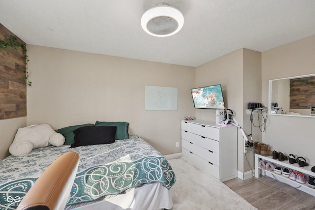 bedroom with light wood-style floors and baseboards