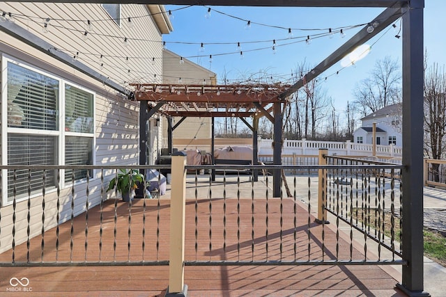 wooden terrace with a patio area, a pergola, and fence