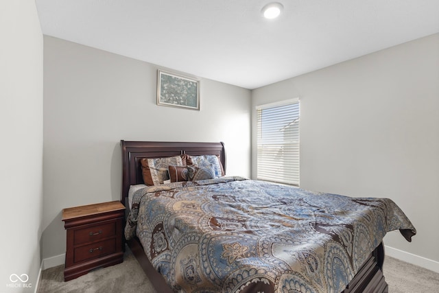 bedroom with baseboards and carpet