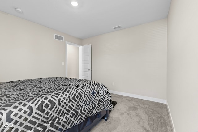 bedroom with visible vents, baseboards, and carpet