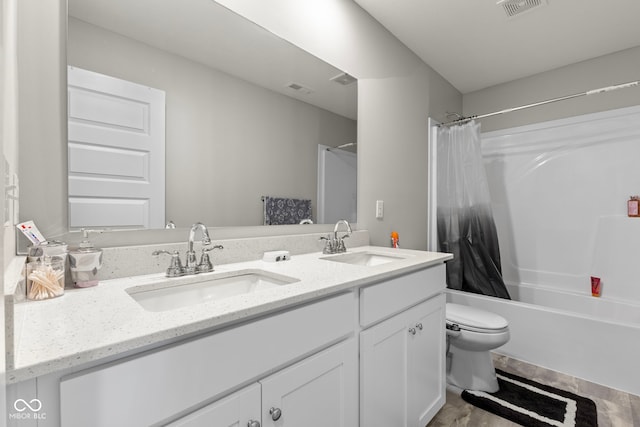 full bathroom featuring double vanity, toilet, visible vents, and a sink