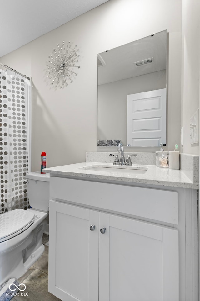 bathroom featuring visible vents, toilet, vanity, and a shower with curtain