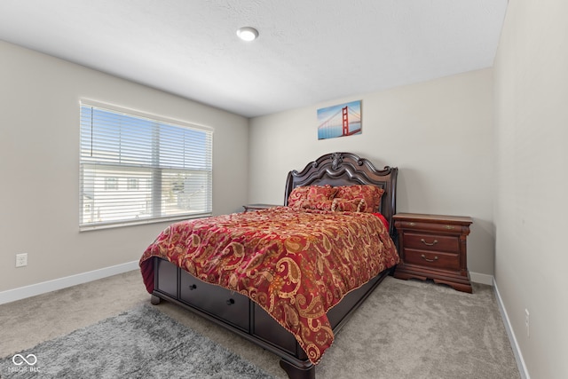 carpeted bedroom with baseboards