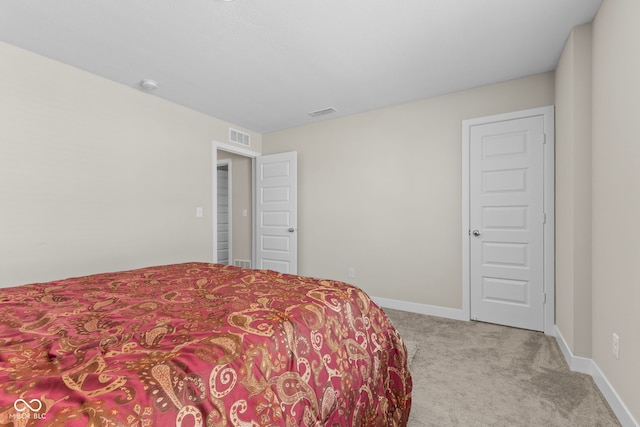 carpeted bedroom with visible vents and baseboards