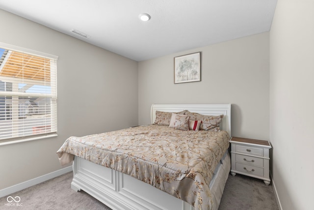 carpeted bedroom featuring visible vents and baseboards