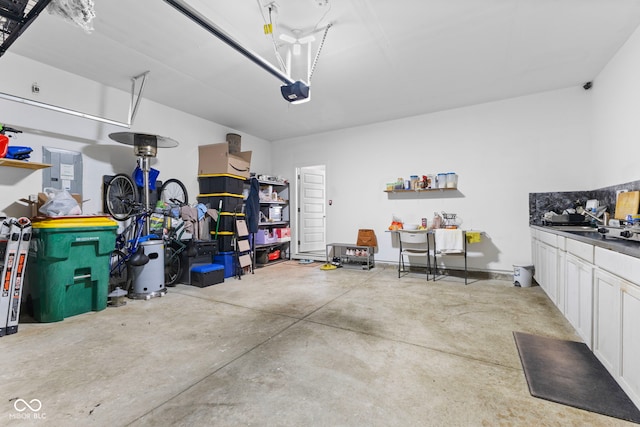 garage with a sink and a garage door opener