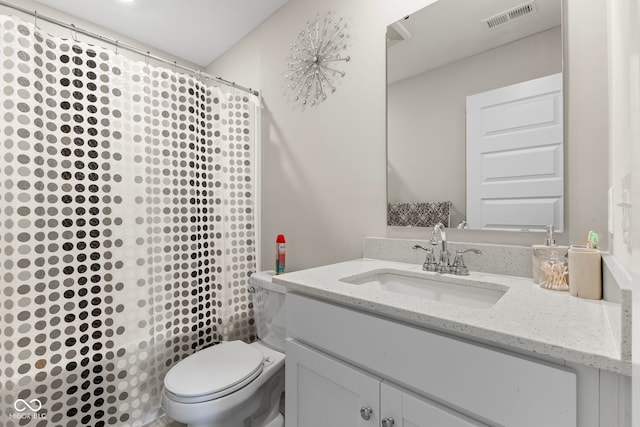 bathroom featuring visible vents, toilet, vanity, and a shower with shower curtain