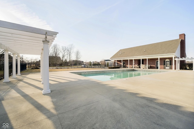 pool featuring fence, a pergola, and a patio area