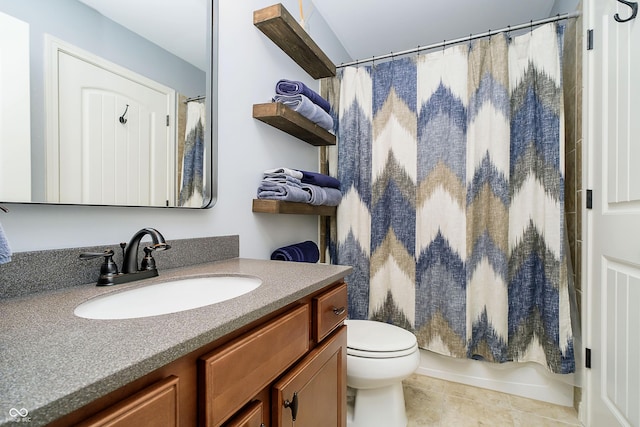 bathroom with vanity, toilet, shower / bath combo with shower curtain, and tile patterned flooring