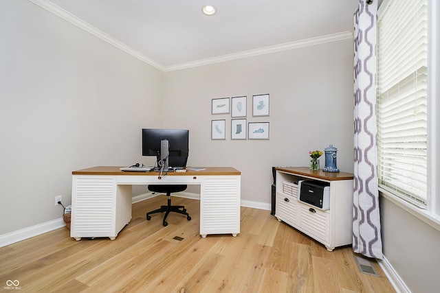 home office featuring visible vents, baseboards, light wood-style floors, and ornamental molding