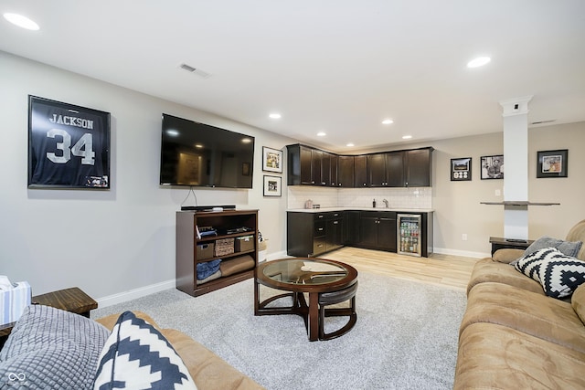 living area featuring visible vents, recessed lighting, wine cooler, indoor wet bar, and baseboards