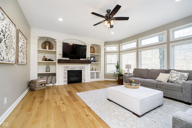 living room featuring wood finished floors, baseboards, recessed lighting, a tile fireplace, and ceiling fan