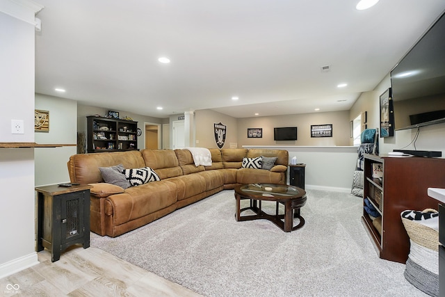 living room with recessed lighting, visible vents, and baseboards