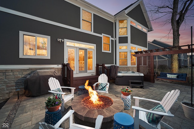 view of patio featuring a fire pit and a hot tub