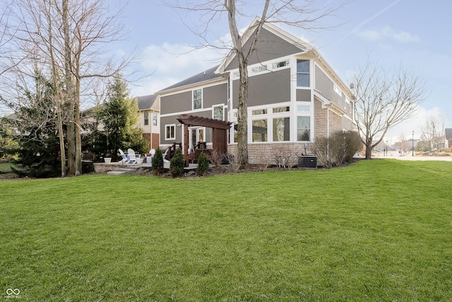 rear view of property with a patio area, a lawn, a pergola, and stucco siding