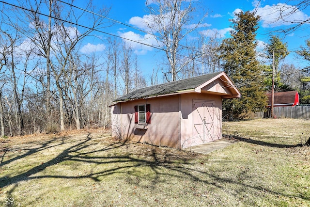 view of shed featuring fence