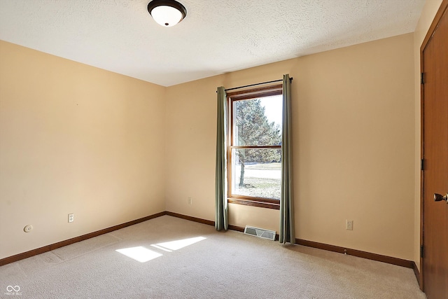 unfurnished room featuring visible vents, a healthy amount of sunlight, light colored carpet, and baseboards