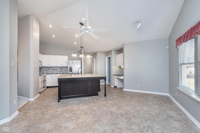 kitchen featuring a kitchen island with sink, stainless steel appliances, white cabinets, lofted ceiling, and ceiling fan