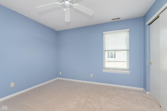 unfurnished room featuring visible vents, baseboards, carpet, and ceiling fan