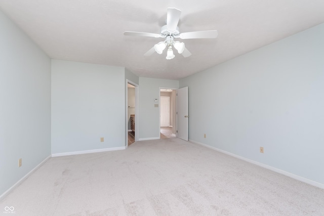 unfurnished bedroom with connected bathroom, baseboards, carpet floors, and ceiling fan