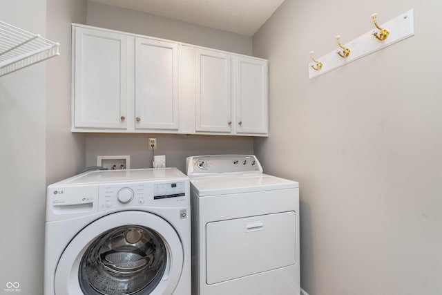 laundry room with cabinet space and washing machine and clothes dryer