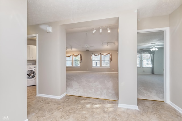 unfurnished room with washer / dryer, ceiling fan, and carpet floors