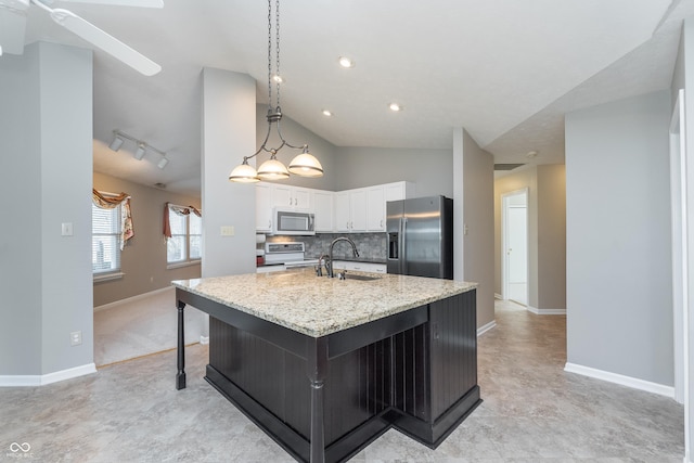 kitchen featuring a large island, a sink, white cabinetry, appliances with stainless steel finishes, and decorative backsplash