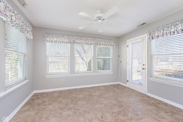 empty room with visible vents, plenty of natural light, baseboards, and ceiling fan