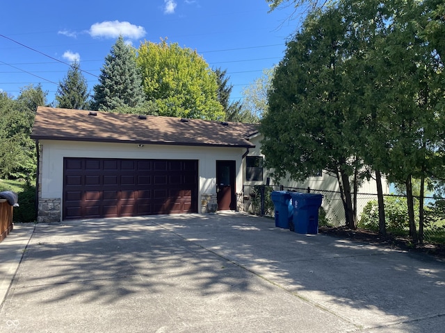 detached garage featuring fence