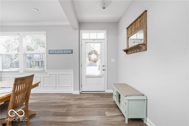 foyer with beamed ceiling, plenty of natural light, and wood finished floors