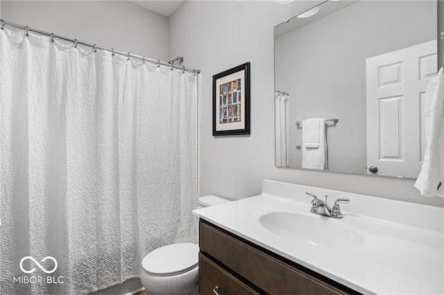 bathroom featuring toilet and vanity