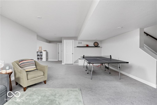 recreation room with carpet, visible vents, and baseboards