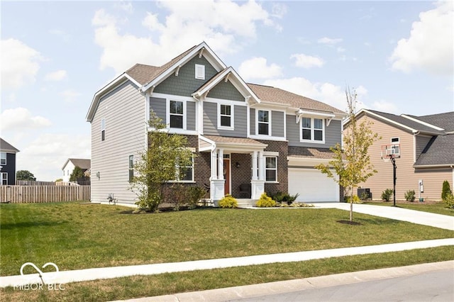 craftsman inspired home with a garage, concrete driveway, a front lawn, and fence