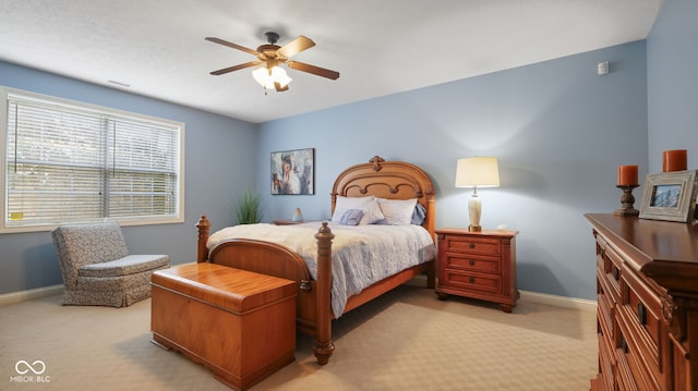 bedroom featuring a ceiling fan, baseboards, and light carpet