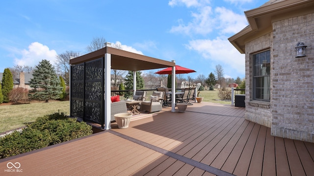 wooden terrace featuring outdoor dining area and a yard