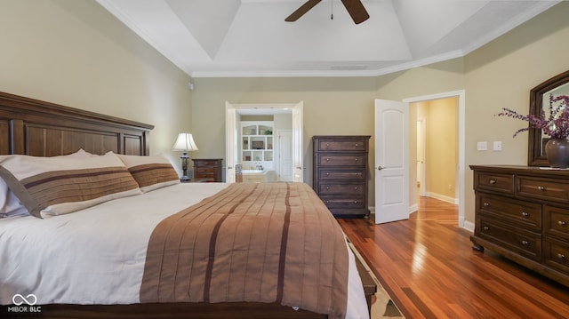 bedroom featuring ensuite bathroom, dark wood finished floors, crown molding, baseboards, and ceiling fan