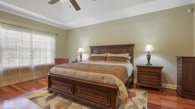 bedroom featuring vaulted ceiling, baseboards, a ceiling fan, and wood finished floors