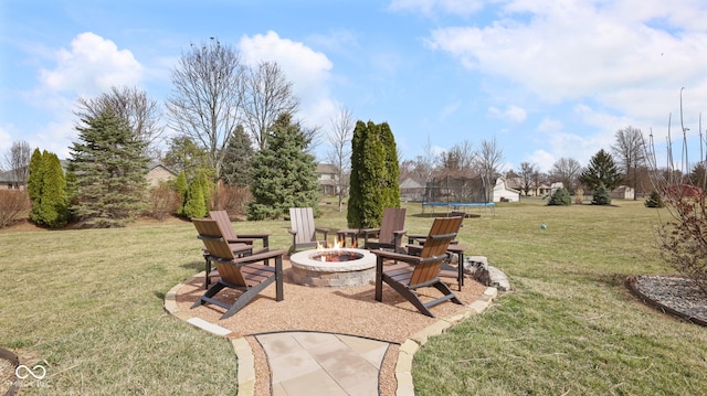 view of yard featuring a patio area, an outdoor fire pit, and a trampoline