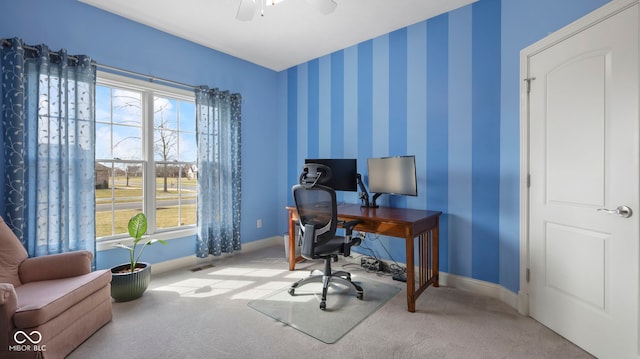 carpeted office space with baseboards, a ceiling fan, and wallpapered walls