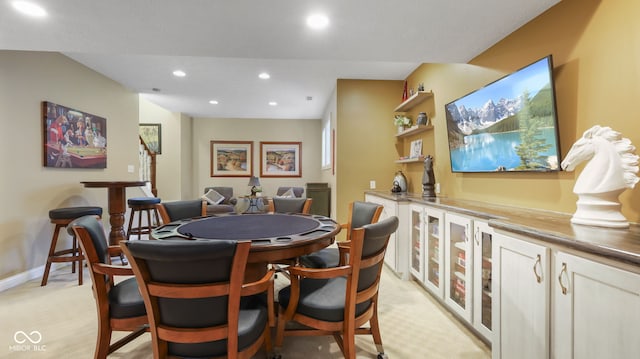 dining space with recessed lighting, light colored carpet, and baseboards