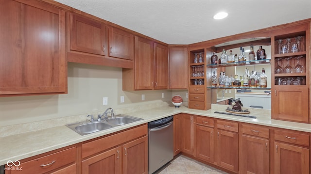 kitchen with dishwasher, light countertops, open shelves, and a sink