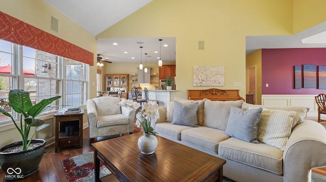 living area featuring visible vents, recessed lighting, wainscoting, high vaulted ceiling, and dark wood-style flooring