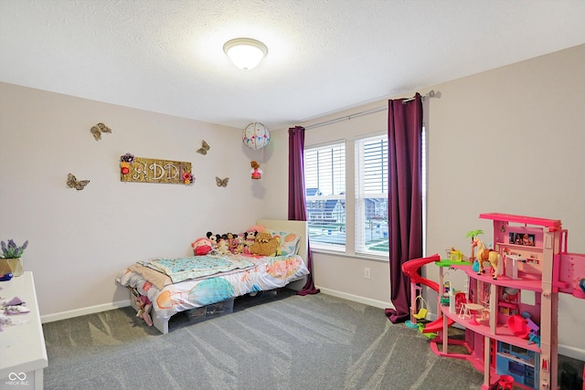 bedroom featuring carpet flooring, a textured ceiling, and baseboards