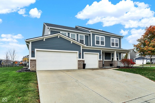 view of front facade with brick siding, a front yard, a porch, and driveway