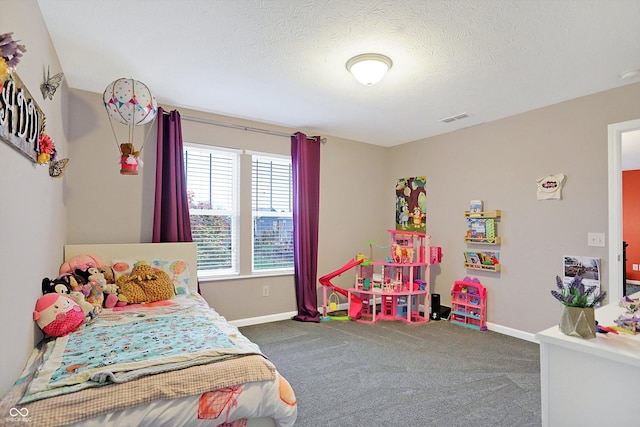 bedroom featuring carpet flooring, baseboards, and a textured ceiling