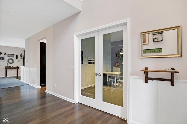 doorway with french doors, baseboards, and dark wood-type flooring