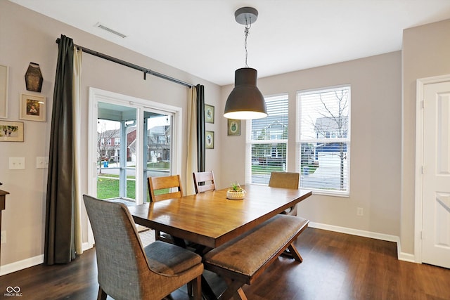 dining area featuring a wealth of natural light, visible vents, baseboards, and dark wood-type flooring