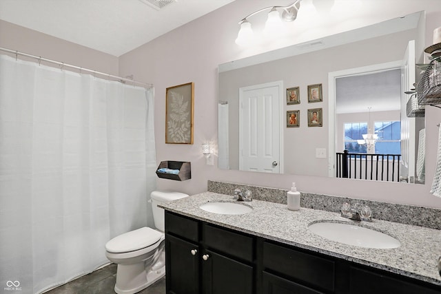 full bath featuring double vanity, toilet, visible vents, and a sink