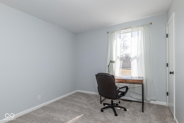 carpeted office featuring baseboards