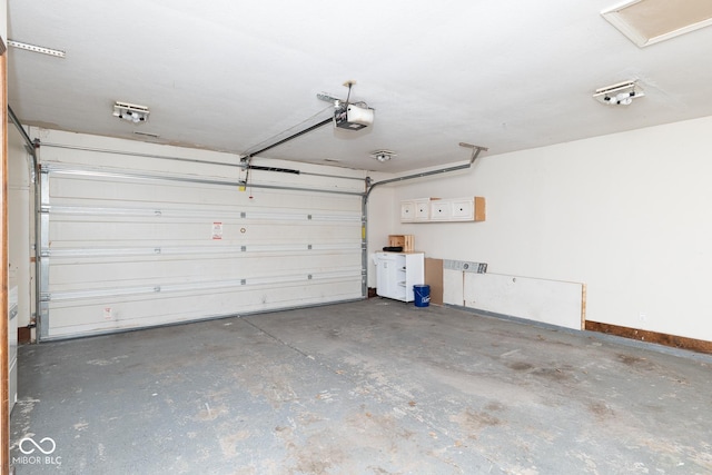 garage with a garage door opener and baseboards